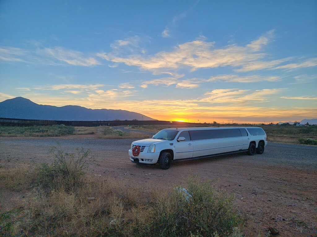 white limousine in front of arizona sunset